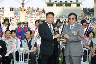 東華三院第四副主席兼學務委員會主任委員馮敬偉(左)致送紀念品予教育局首席教育主任徐啓祥。