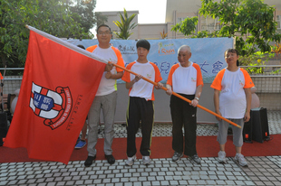 東華三院主席施榮恆先生(左一)在誓師大會上授旗予運動員代表區俊華(左二)、謝玉成(右二)及蘇潔萍,為他們打氣。