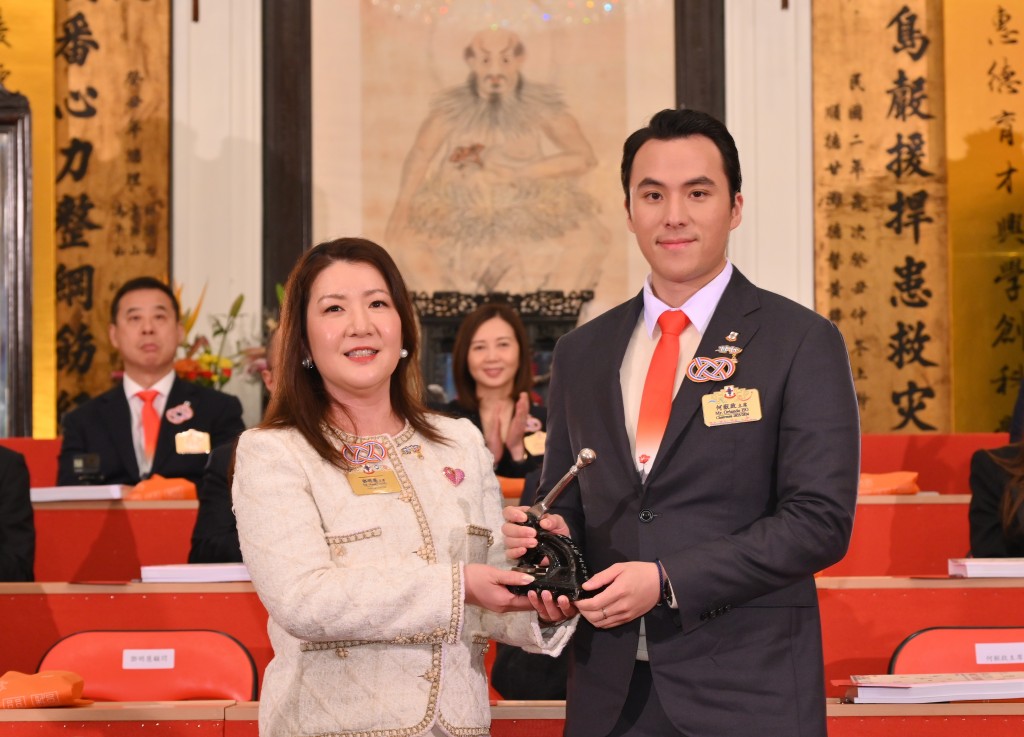 圖二：東華三院甲辰年董事局主席鄧明慧女士（左）移交契據及印信予乙巳年董事局主席何猷啟先生（右）。