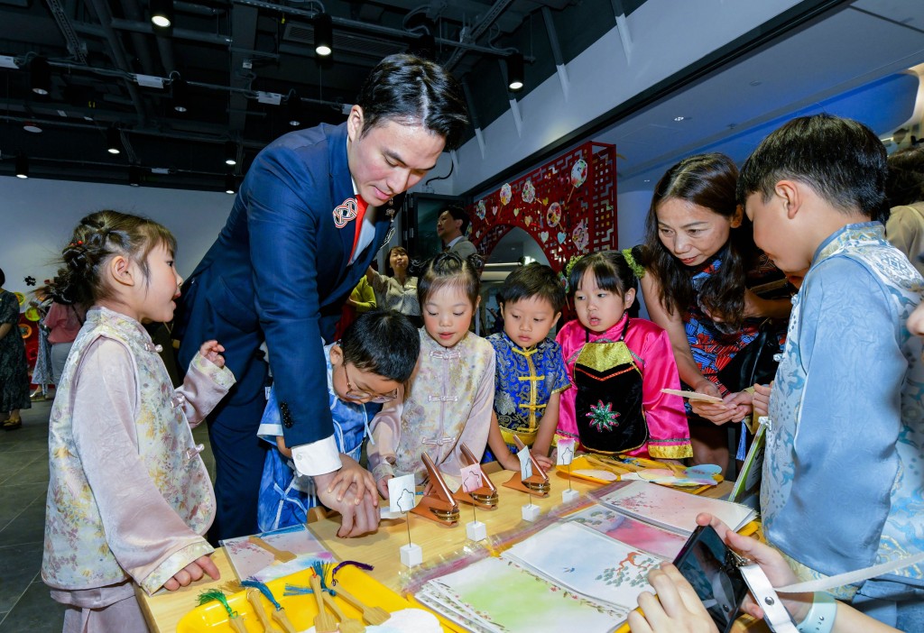 圖三為東華三院主席暨幼稚園校監何猷啟先生（左二）和教育局副秘書長李碧茜女士太平紳士（右二）在展區與學生代表即席創作。